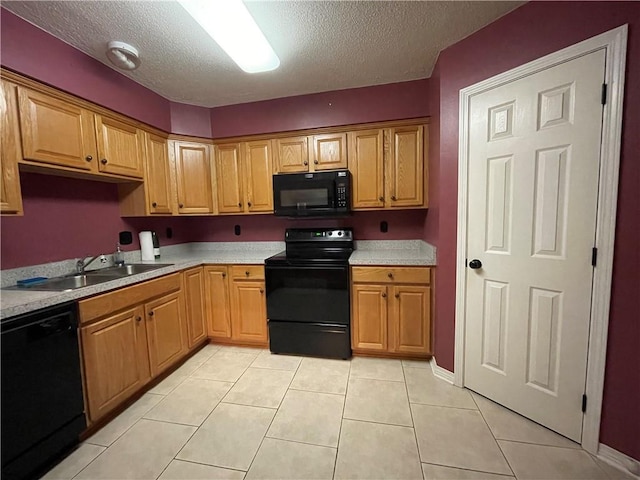 kitchen with sink, a textured ceiling, black appliances, and light tile floors