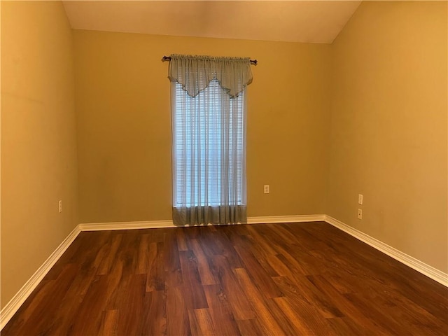 unfurnished room with dark hardwood / wood-style flooring