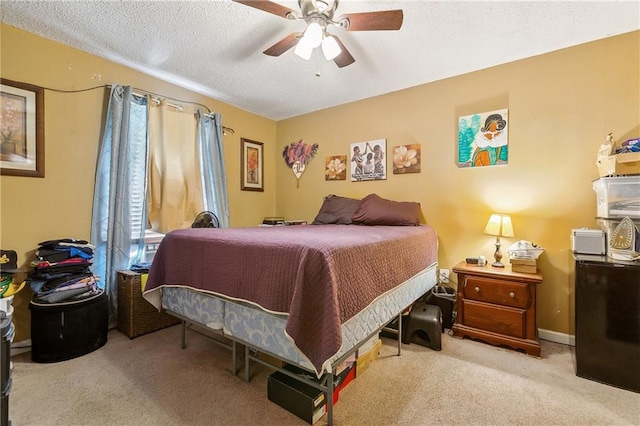 bedroom with ceiling fan, a textured ceiling, and carpet flooring