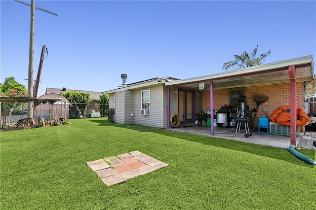 back of property with a patio and a yard