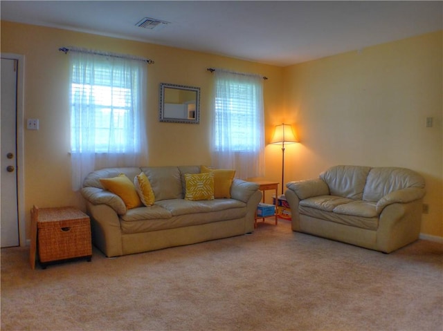 living room featuring light carpet and a wealth of natural light