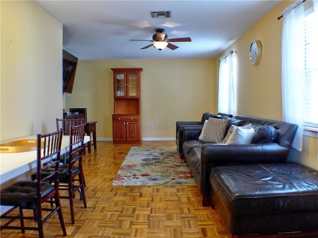 living room featuring ceiling fan and light parquet flooring