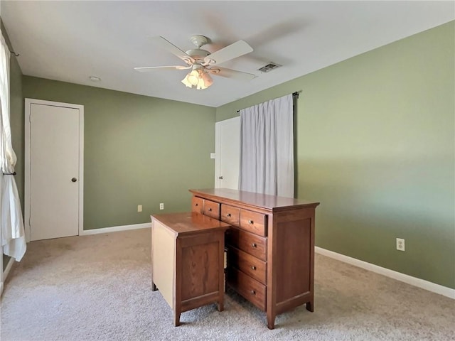 home office featuring ceiling fan and light colored carpet