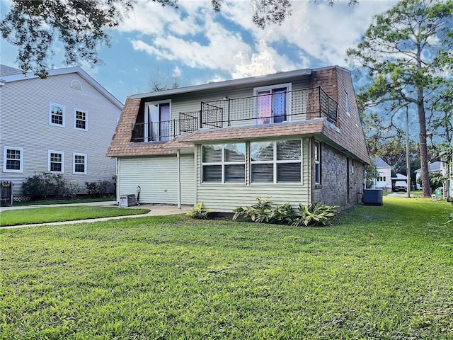 back of house featuring a yard, a balcony, and central AC unit