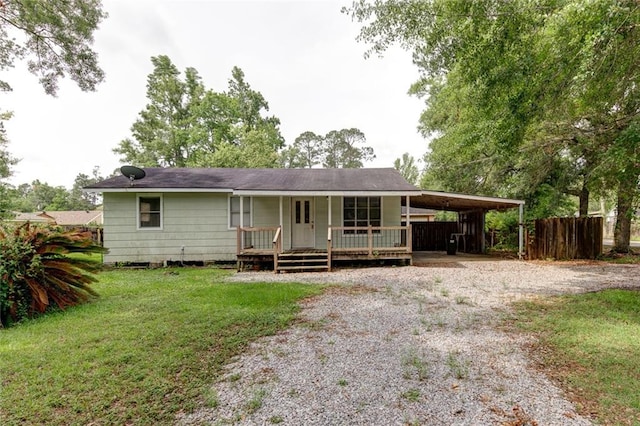 view of front facade with a front lawn, a carport, and a porch