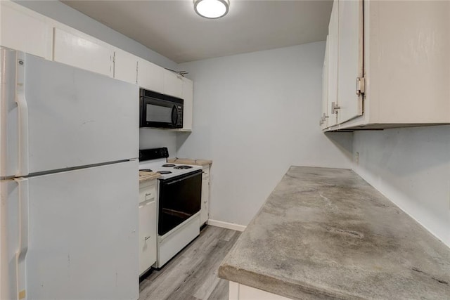 kitchen with white cabinets, white appliances, and light hardwood / wood-style flooring