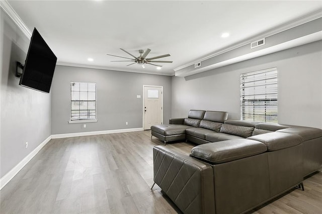 living room with ceiling fan, light wood-type flooring, and ornamental molding