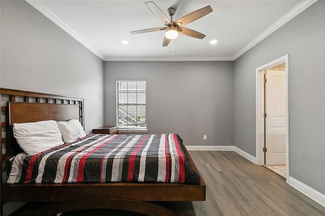 bedroom featuring crown molding, hardwood / wood-style flooring, and ceiling fan