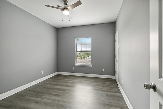 empty room with dark wood-type flooring and ceiling fan