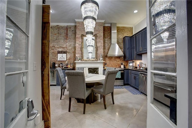 dining space with brick wall, a notable chandelier, sink, and ornamental molding