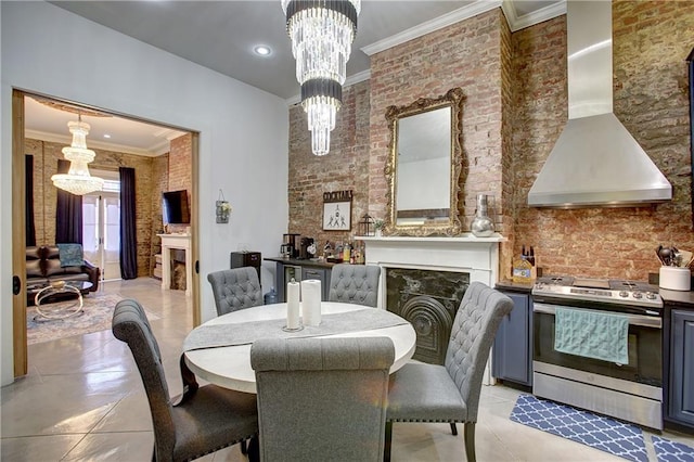 dining area featuring brick wall, light tile floors, and an inviting chandelier