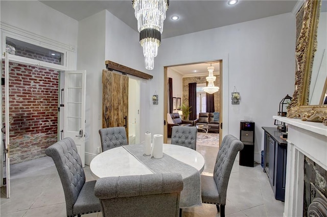 dining area featuring a notable chandelier, a fireplace, and light tile floors