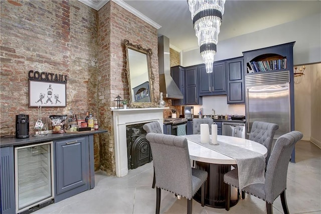 tiled dining area with beverage cooler, a notable chandelier, brick wall, and crown molding