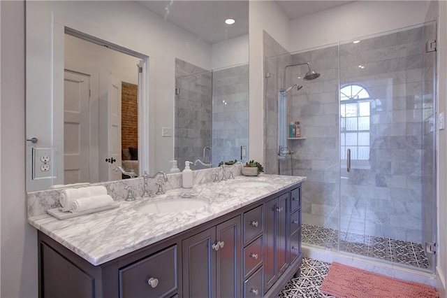 bathroom featuring tile floors, a shower with door, double sink, and large vanity