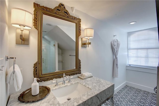 bathroom featuring tile flooring, oversized vanity, and lofted ceiling