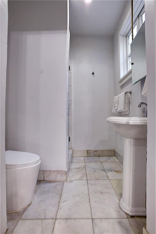 bathroom with tile flooring and toilet