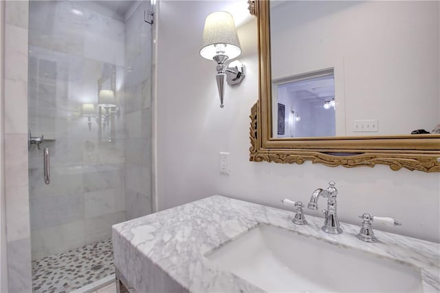 bathroom featuring a shower with door and oversized vanity