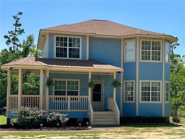 view of front of house featuring a front yard and covered porch