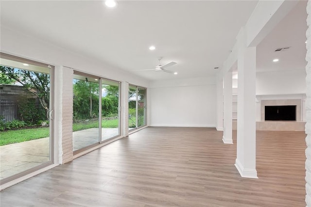 interior space featuring ceiling fan, light hardwood / wood-style flooring, and a healthy amount of sunlight