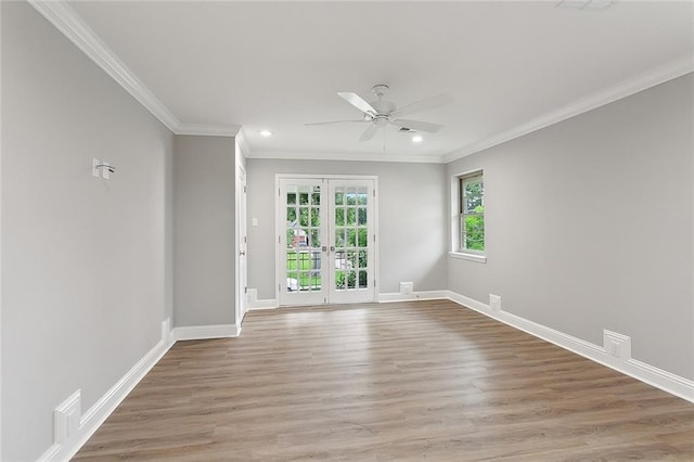 spare room featuring ceiling fan, hardwood / wood-style flooring, crown molding, and french doors