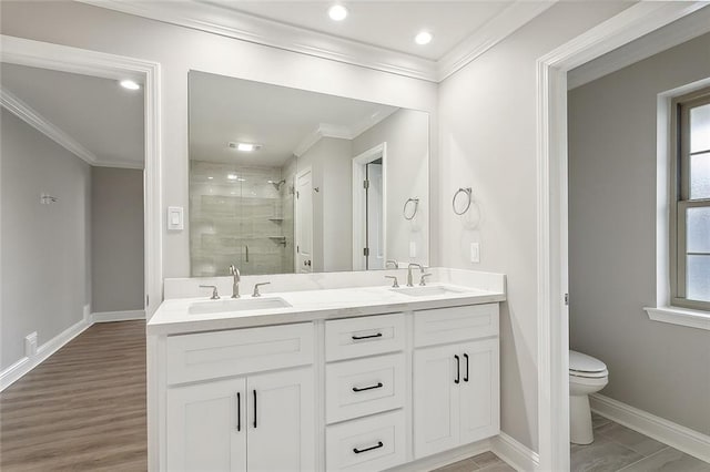 bathroom featuring hardwood / wood-style floors, ornamental molding, a shower with shower door, vanity, and toilet