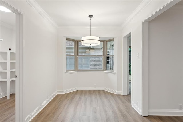 unfurnished dining area featuring light hardwood / wood-style flooring and ornamental molding