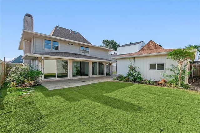 rear view of property featuring a patio area and a yard