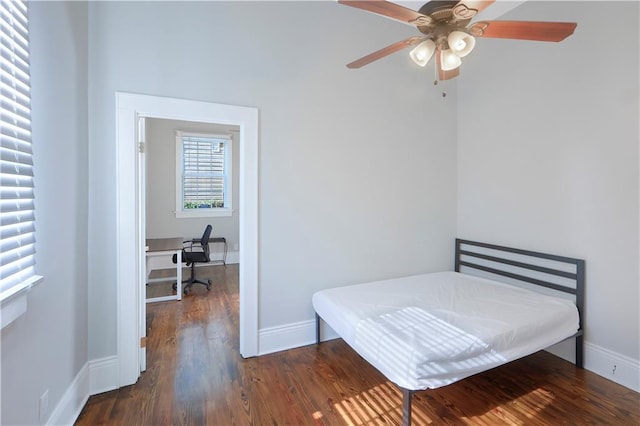 bedroom featuring ceiling fan and dark wood-type flooring