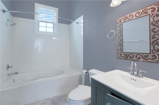 full bathroom featuring tile floors, tiled shower / bath combo, toilet, and vanity with extensive cabinet space