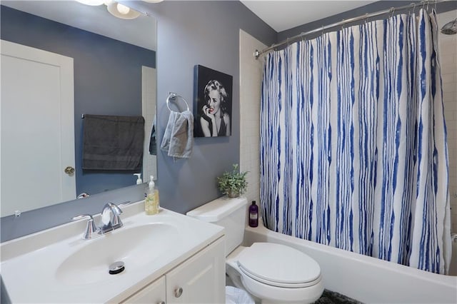 full bathroom featuring shower / tub combo with curtain, toilet, and vanity