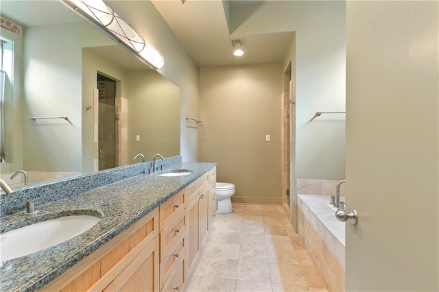 full bathroom featuring oversized vanity, toilet, tile floors, shower with separate bathtub, and double sink