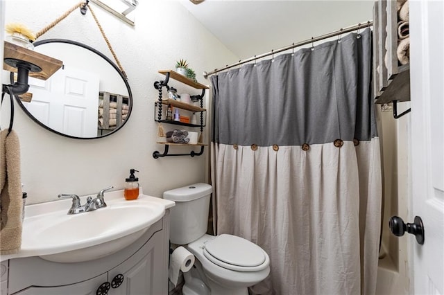 bathroom featuring oversized vanity and toilet