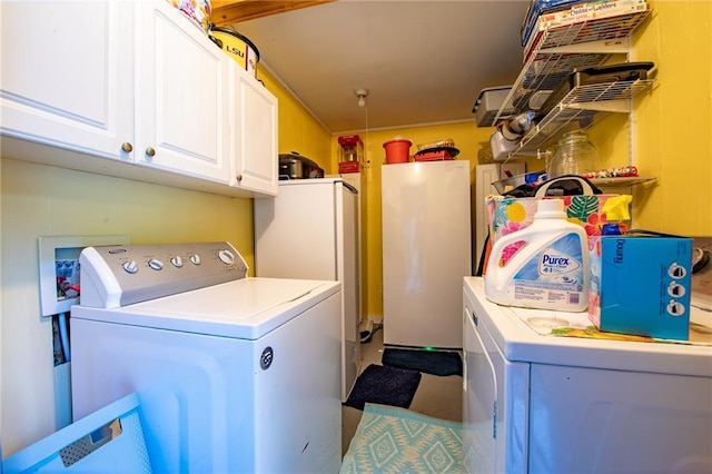 laundry area featuring separate washer and dryer, washer hookup, and cabinets