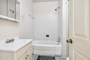 bathroom with vanity and tiled shower / bath