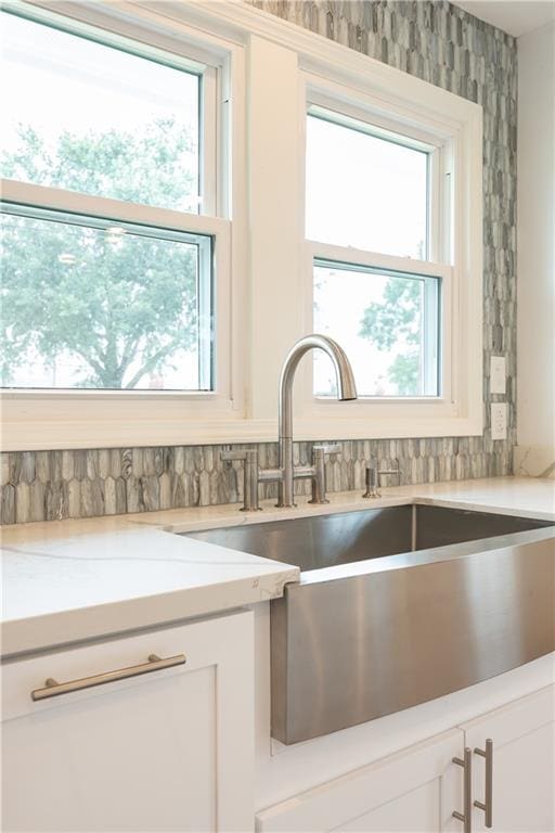 kitchen featuring sink and white cabinets