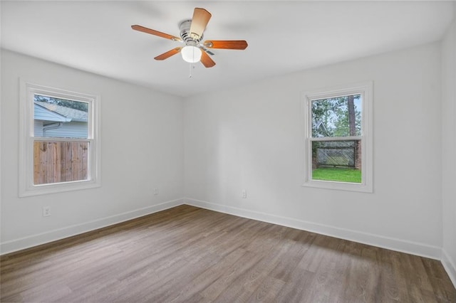 spare room featuring ceiling fan and dark hardwood / wood-style flooring