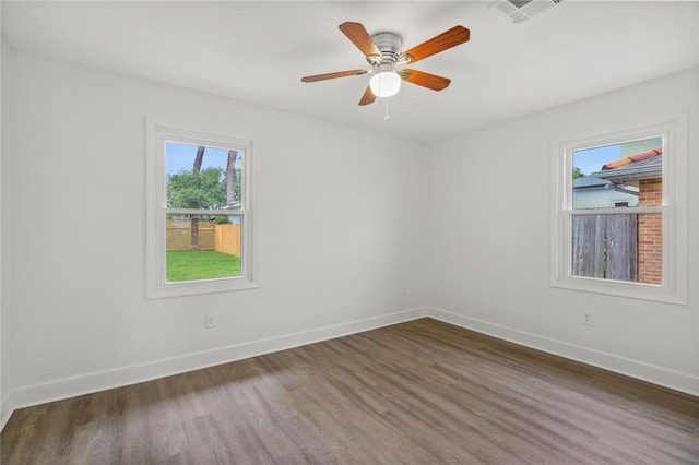 unfurnished room with dark hardwood / wood-style floors and ceiling fan