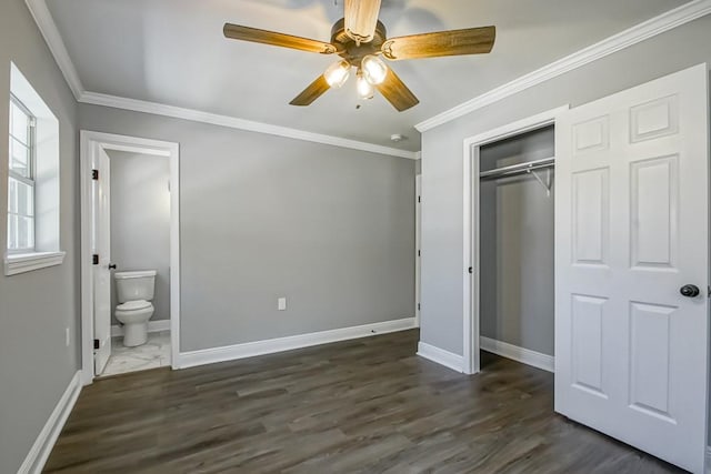 unfurnished bedroom with a closet, ceiling fan, ornamental molding, dark wood-type flooring, and ensuite bath