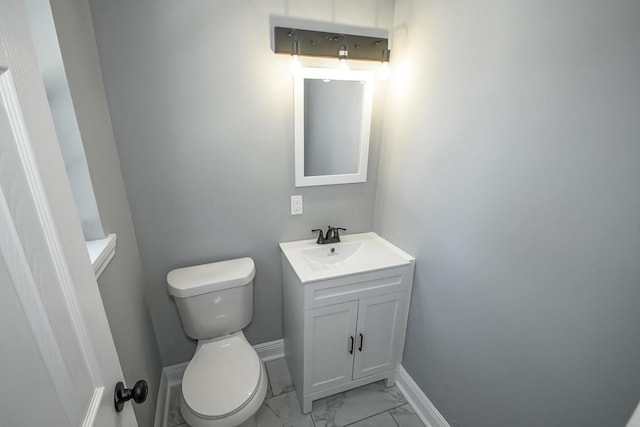 bathroom featuring tile flooring, vanity, and toilet