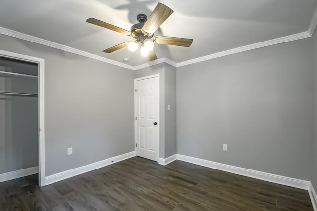 unfurnished bedroom with ornamental molding, dark wood-type flooring, a closet, and ceiling fan