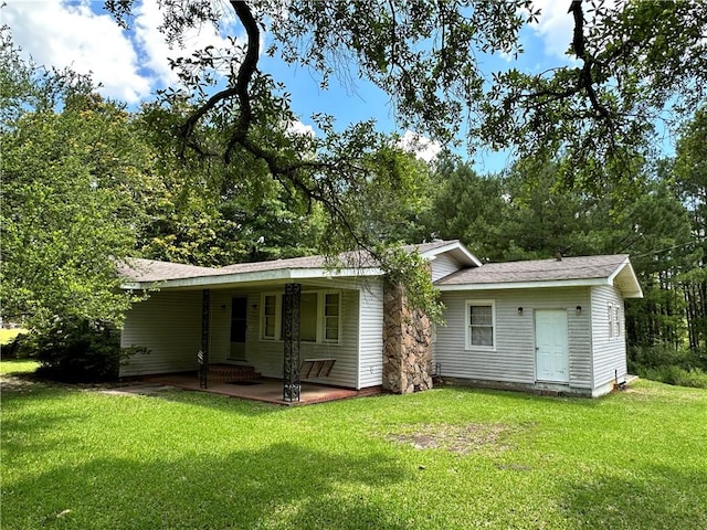 back of property featuring a yard and a patio