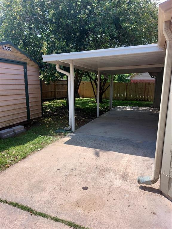 view of vehicle parking with a carport