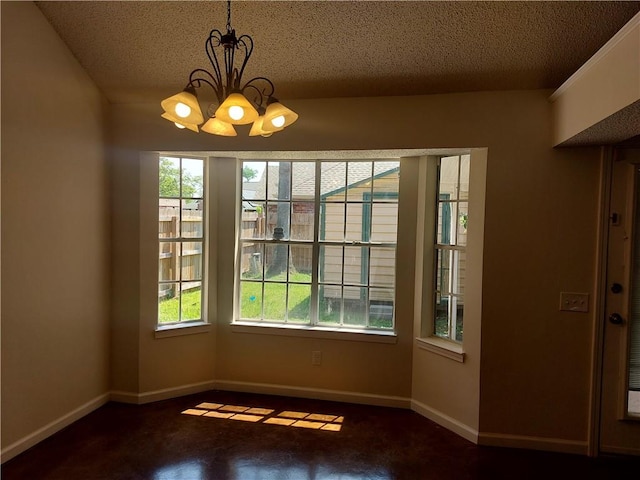 unfurnished dining area with a notable chandelier and a textured ceiling