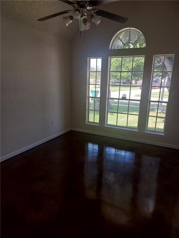 empty room featuring plenty of natural light, ceiling fan, and a textured ceiling