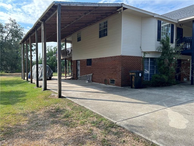 view of property exterior with a carport and a lawn