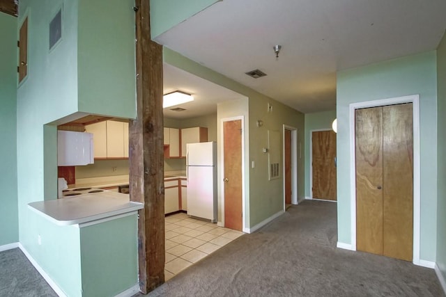 kitchen featuring light carpet, white appliances, white cabinets, and kitchen peninsula