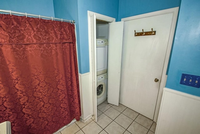 bathroom featuring tile floors and stacked washing maching and dryer