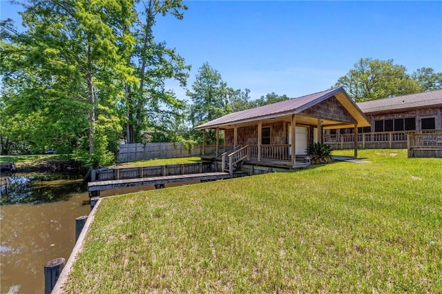 exterior space featuring a yard and a water view