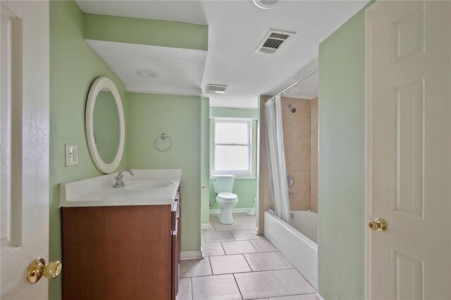 full bathroom with tile flooring, large vanity, toilet, and shower / bath combo with shower curtain