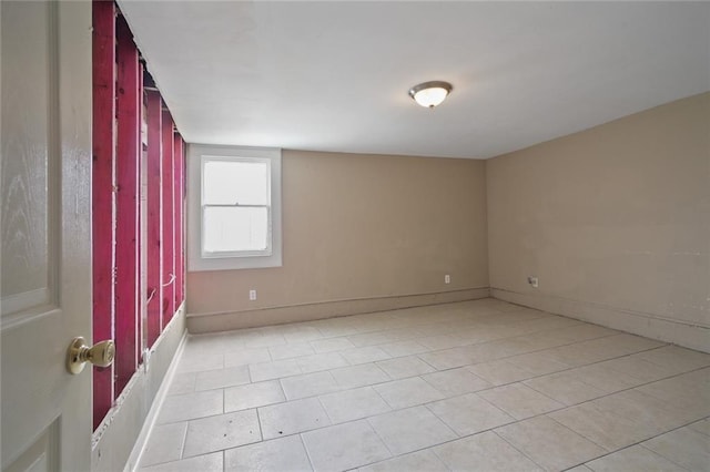 unfurnished room with baseboards